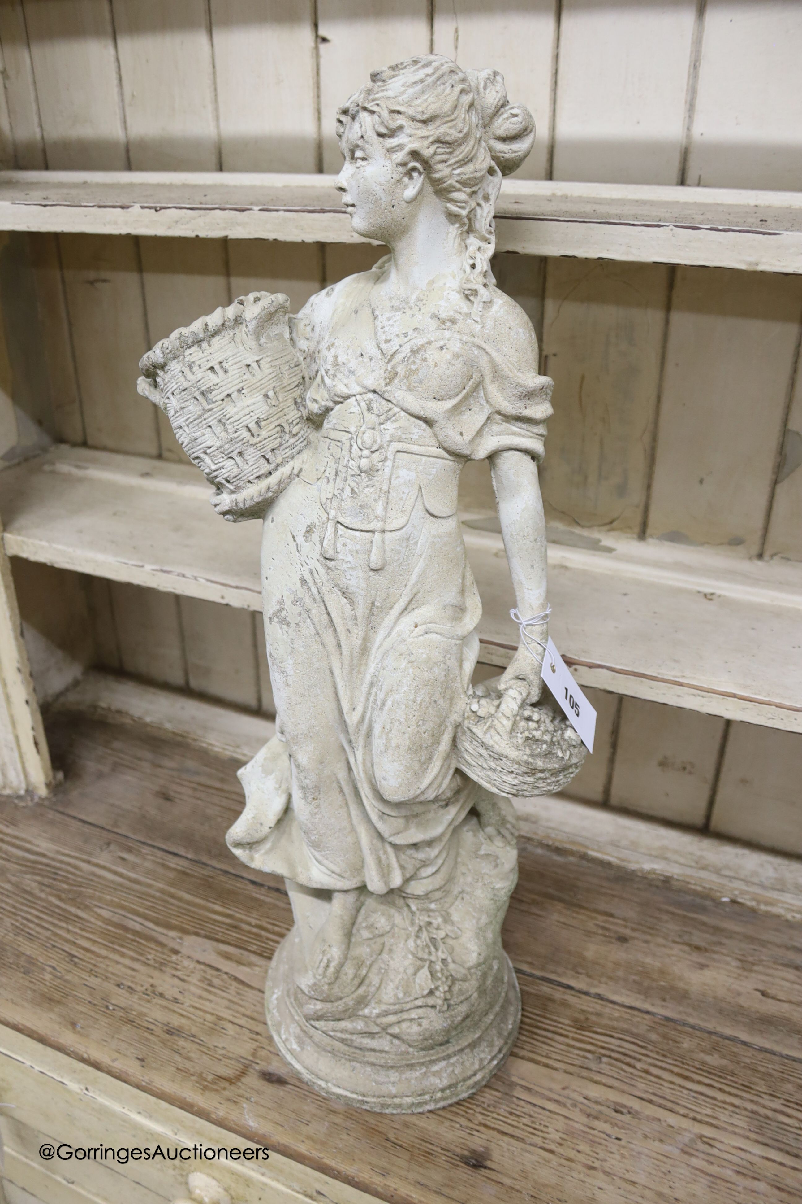 A reconstituted stone figure of a female fruit picker, height 69cm